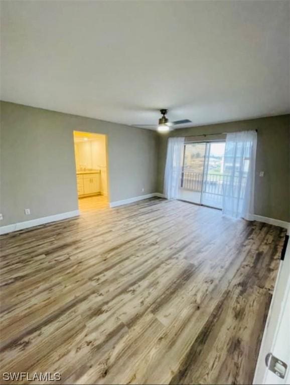 empty room featuring ceiling fan and light wood-type flooring