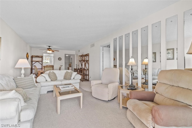 living room featuring ceiling fan and light colored carpet