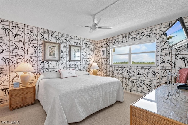 carpeted bedroom featuring a textured ceiling and ceiling fan