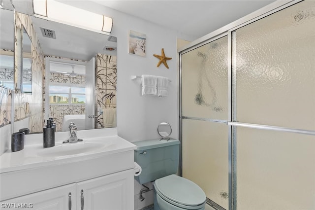 bathroom featuring toilet, an enclosed shower, and oversized vanity