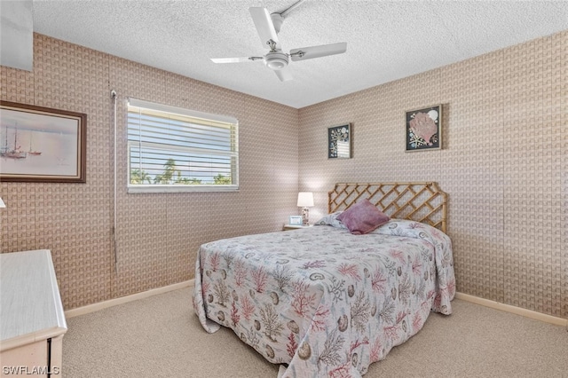 carpeted bedroom featuring a textured ceiling and ceiling fan