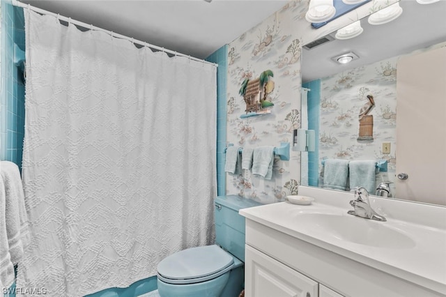 bathroom with toilet and vanity with extensive cabinet space