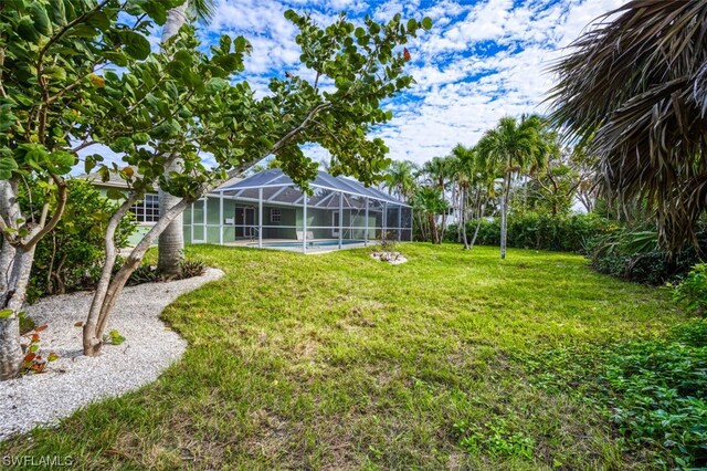 view of yard featuring glass enclosure