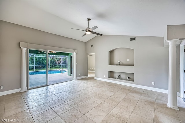 empty room featuring light tile flooring, decorative columns, vaulted ceiling, and ceiling fan