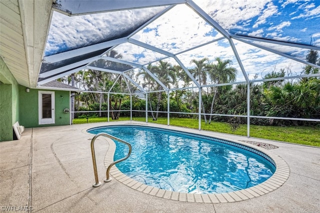 view of pool with a patio area and a lanai