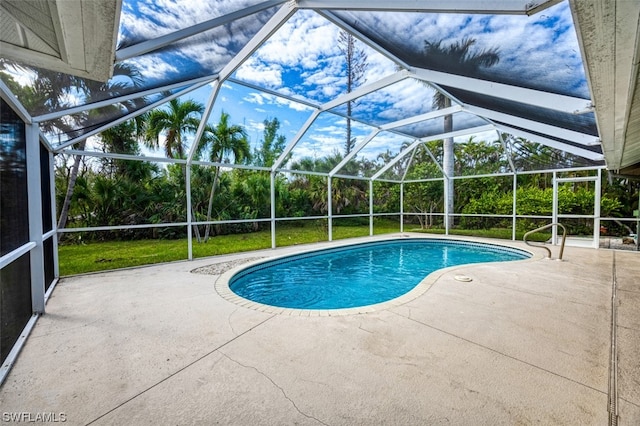 view of pool with a patio area and a lanai