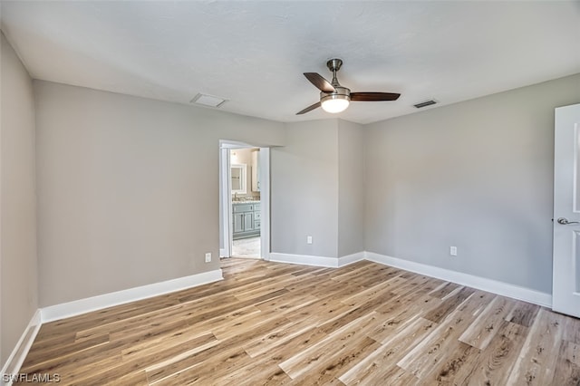 empty room featuring ceiling fan and light hardwood / wood-style flooring