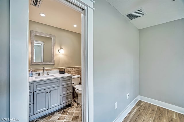 bathroom featuring oversized vanity, toilet, and tile floors