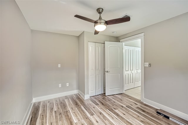 unfurnished bedroom with light hardwood / wood-style floors and ceiling fan