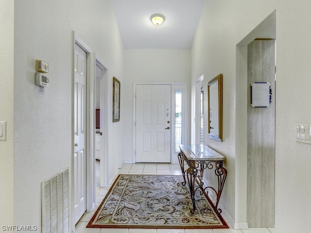 entryway featuring light tile patterned floors, visible vents, and baseboards