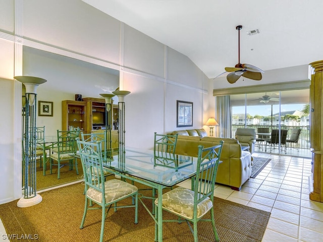 tiled dining room with visible vents, high vaulted ceiling, and ceiling fan