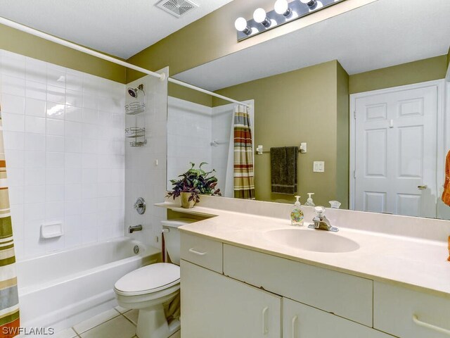 full bath featuring vanity, visible vents, tile patterned floors, toilet, and shower / tub combo with curtain