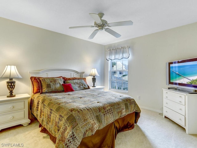 bedroom featuring a ceiling fan, baseboards, and light carpet