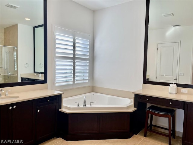 bathroom with vanity, tile patterned flooring, and plus walk in shower