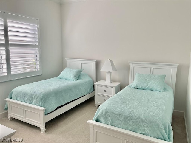 bedroom featuring light colored carpet