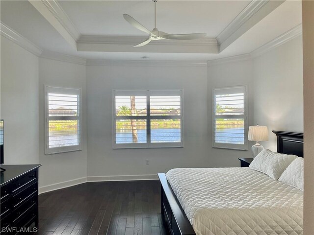 bedroom featuring dark hardwood / wood-style flooring, crown molding, and multiple windows