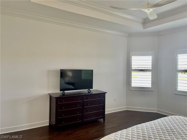 bedroom featuring dark hardwood / wood-style flooring, ceiling fan, and crown molding