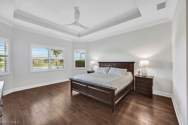 bedroom featuring multiple windows, dark wood-type flooring, and ceiling fan