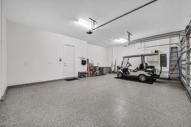 garage with electric panel and a garage door opener