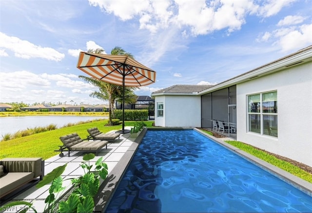 view of pool with a water view, a yard, and a patio