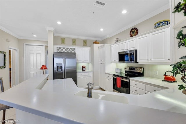 kitchen featuring tasteful backsplash, stainless steel appliances, white cabinetry, and sink