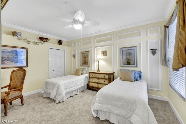 carpeted bedroom with a closet, crown molding, and ceiling fan