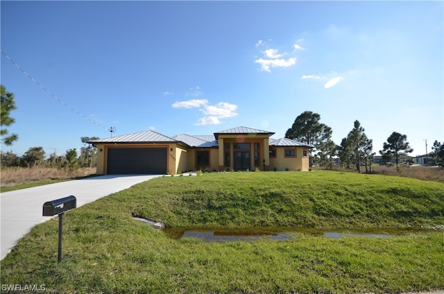 view of front of property with a front lawn and a garage