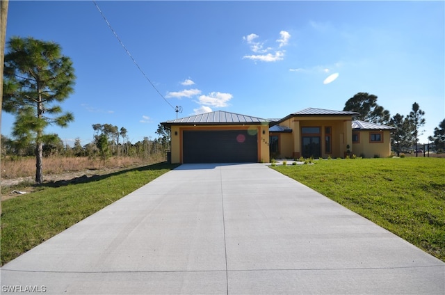 view of front of home with a front yard and a garage