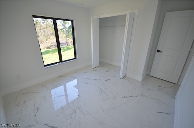 unfurnished bedroom with a closet and light tile floors