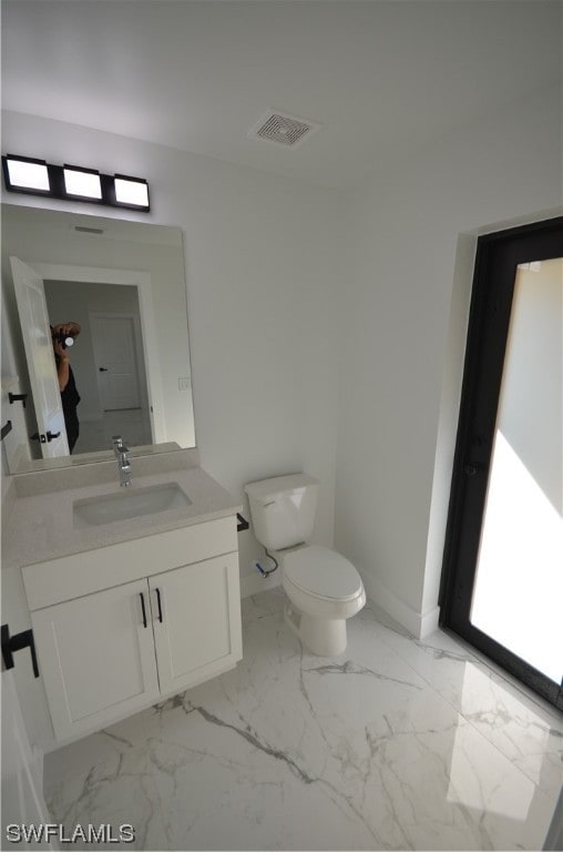 bathroom featuring oversized vanity, toilet, and tile flooring