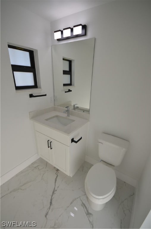 bathroom with vanity, tile flooring, and toilet