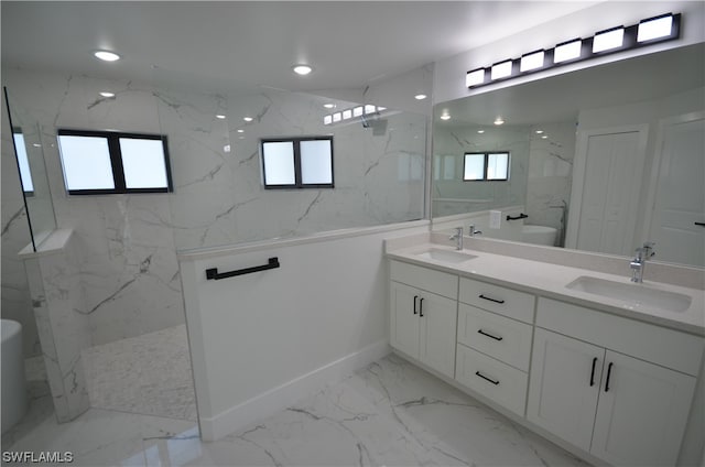 bathroom featuring plenty of natural light, tile floors, dual sinks, and vanity with extensive cabinet space