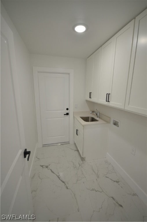 laundry room featuring light tile floors, cabinets, washer hookup, and sink