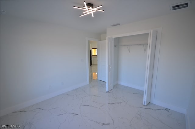 unfurnished bedroom with a closet and light tile floors