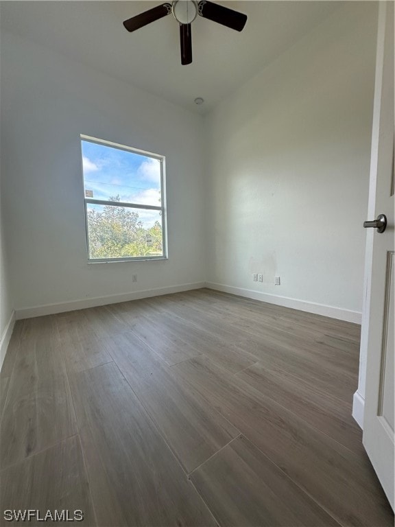 spare room with ceiling fan and dark wood-type flooring