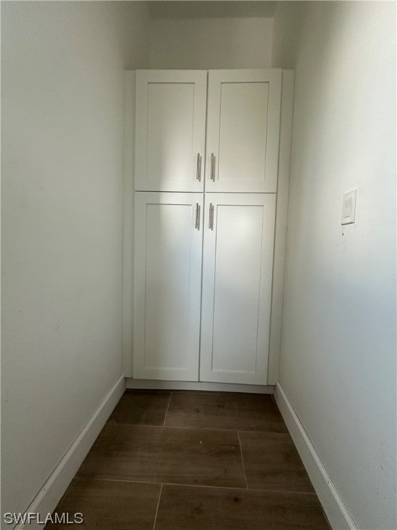 unfurnished bedroom featuring a closet and dark wood-type flooring