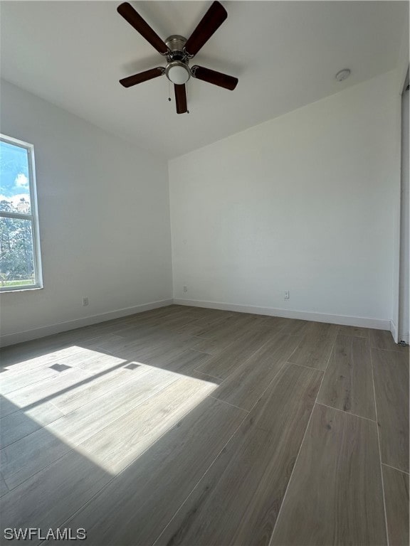 unfurnished room with ceiling fan and light hardwood / wood-style flooring