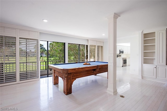 rec room featuring ornate columns, pool table, light wood-type flooring, and built in shelves