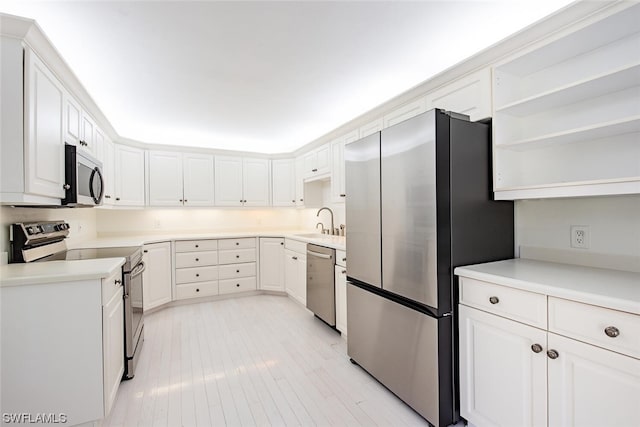 kitchen with sink, appliances with stainless steel finishes, and white cabinetry