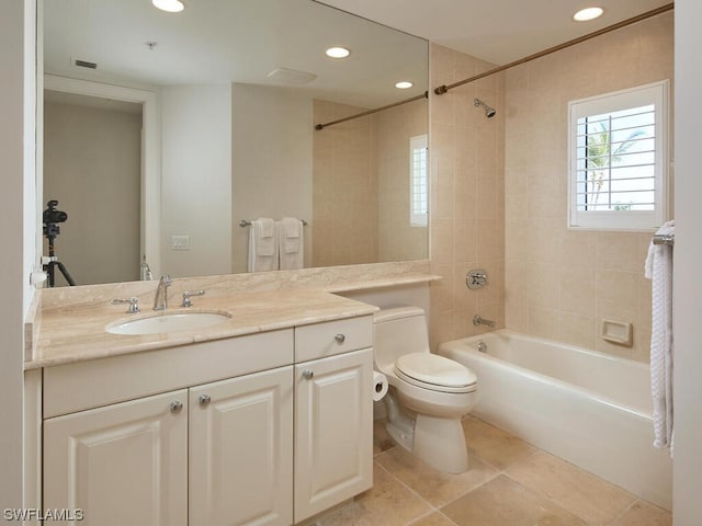 full bathroom featuring toilet, vanity, tiled shower / bath, and tile flooring