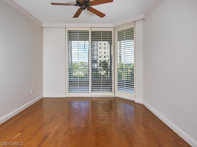 unfurnished room featuring baseboards, wood finished floors, a ceiling fan, and crown molding