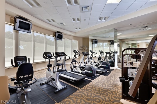 workout area featuring baseboards, visible vents, and a drop ceiling