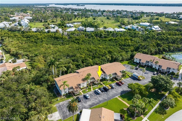 drone / aerial view featuring a water view and a residential view