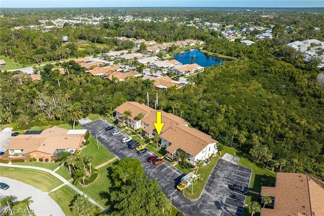 drone / aerial view with a water view and a residential view