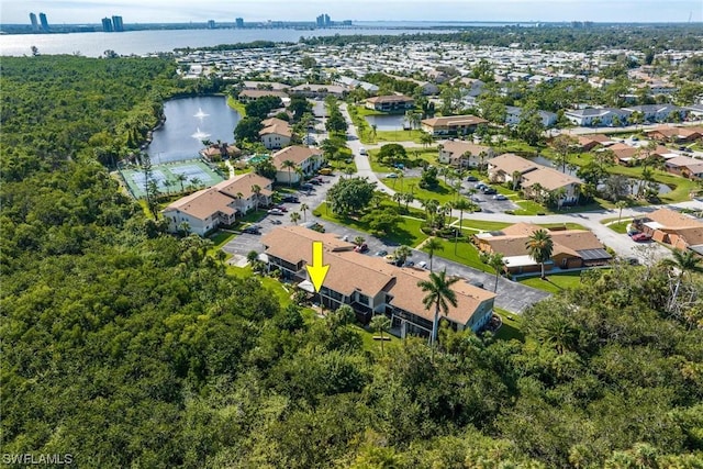 drone / aerial view featuring a residential view and a water view