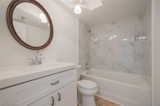 full bathroom featuring vanity, tile patterned flooring, tiled shower / bath combo, and toilet