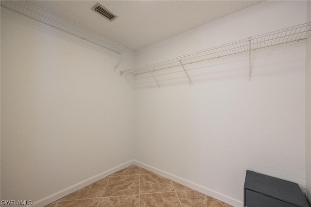 spacious closet featuring light tile patterned flooring and visible vents