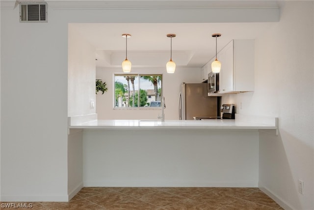 kitchen with a raised ceiling, appliances with stainless steel finishes, kitchen peninsula, white cabinetry, and decorative light fixtures