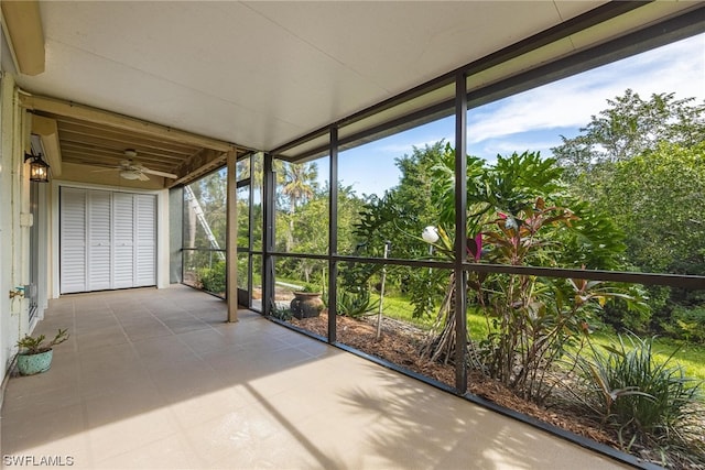 unfurnished sunroom featuring ceiling fan