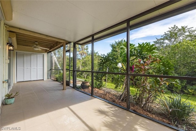 unfurnished sunroom with ceiling fan